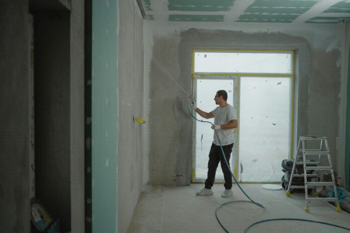 A bright and freshly painted room showcasing efficient painting techniques, with tools like rollers and brushes neatly arranged, emphasizing the process of completing a paint job in one day.