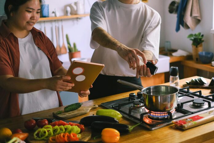 Smart kitchen gadgets including a Wi-Fi-enabled coffee maker and digital scale on a modern kitchen counter