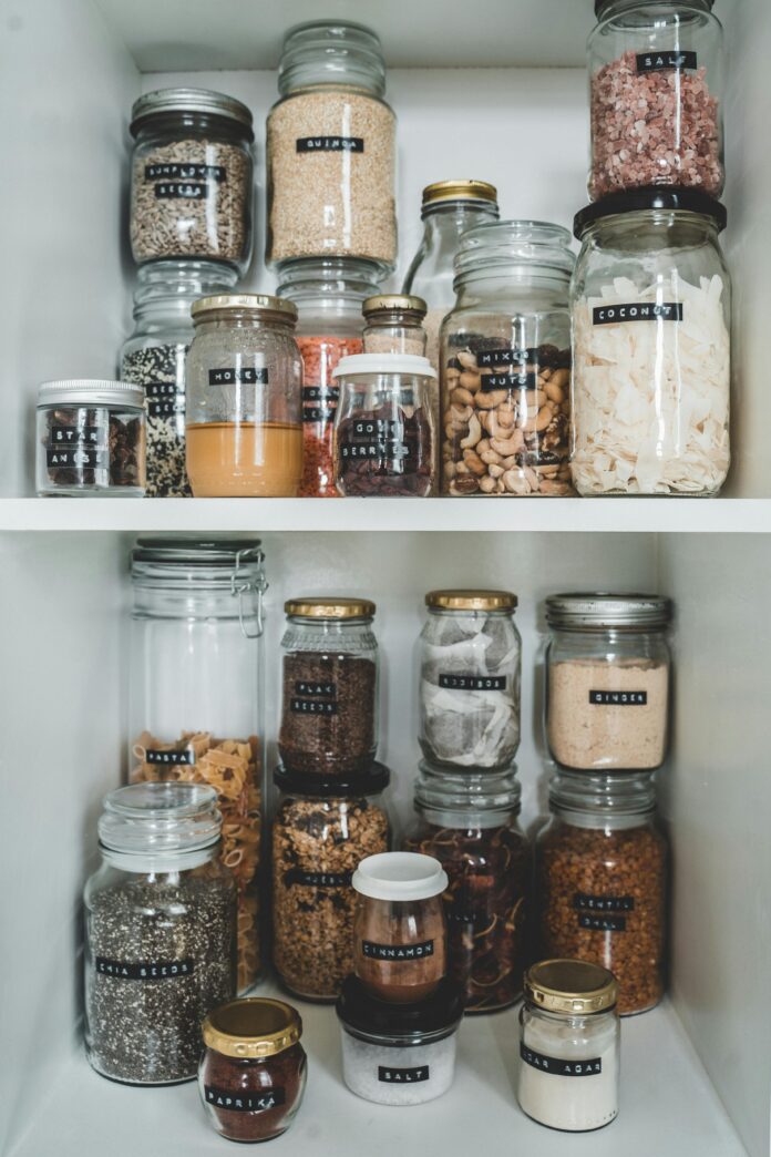 pantry organization tips, including labeled jars, stackable bins, shelf dividers, and a neatly arranged pantry space.