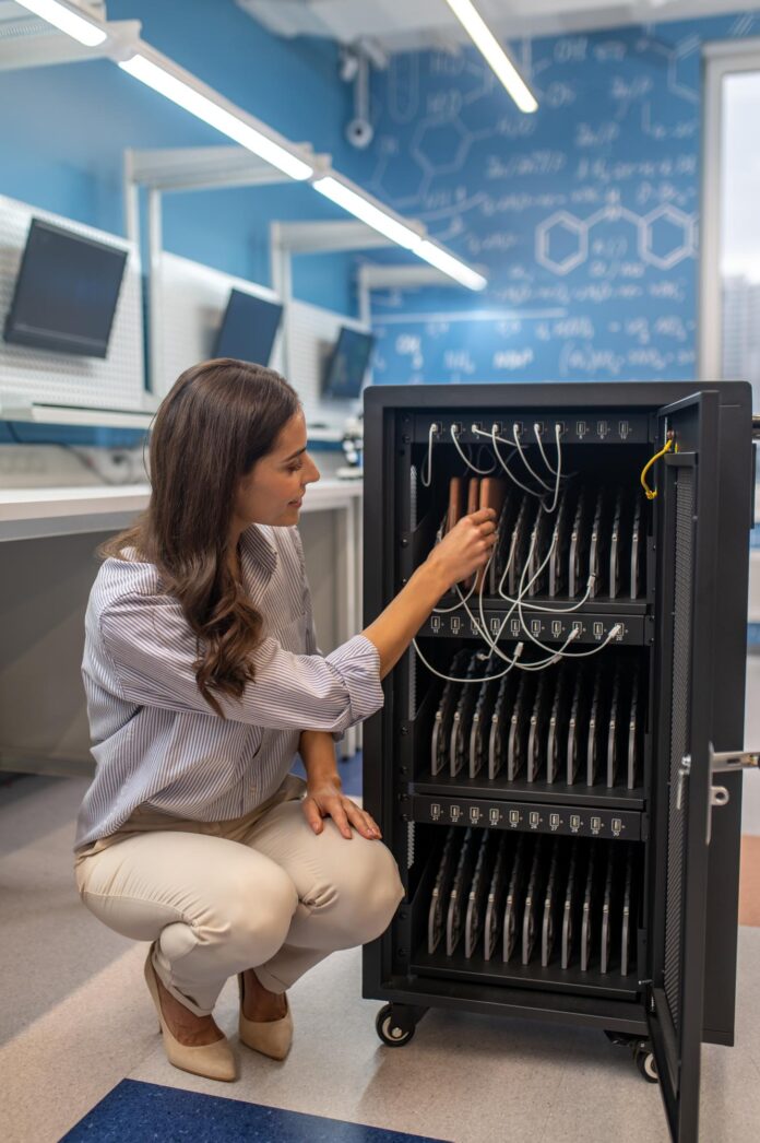 Illustration of organized tech gadget storage featuring neatly arranged devices, charging stations, and cable management tools in a modern setup.