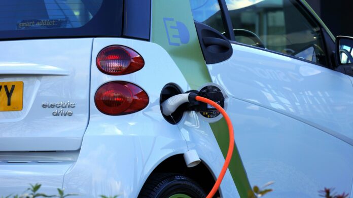 An electric vehicle charging at a modern charging station, symbolizing sustainable transportation and the future of mobility.