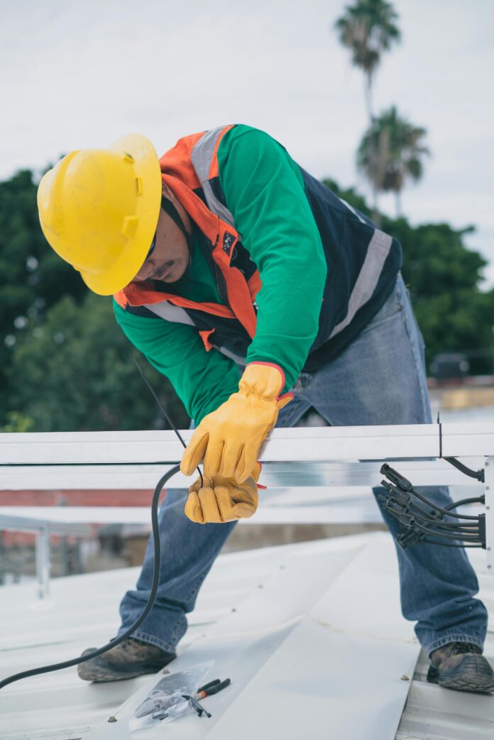 Homeowner inspecting electrical outlets with safety tools, demonstrating proper electrical safety practices to prevent hazards and ensure protection.