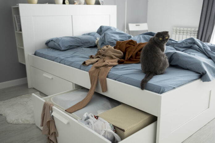 Under-bed storage ideas featuring rolling bins, fabric organizers, and drawers to create extra storage space in small bedrooms.