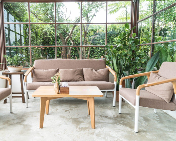 A modern backyard featuring eco-friendly decking made from sustainable, recycled materials, surrounded by lush greenery and stylish outdoor furniture.