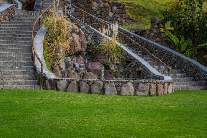 Comparison of hardscaping and landscaping, featuring a backyard with stone pathways and lush greenery.