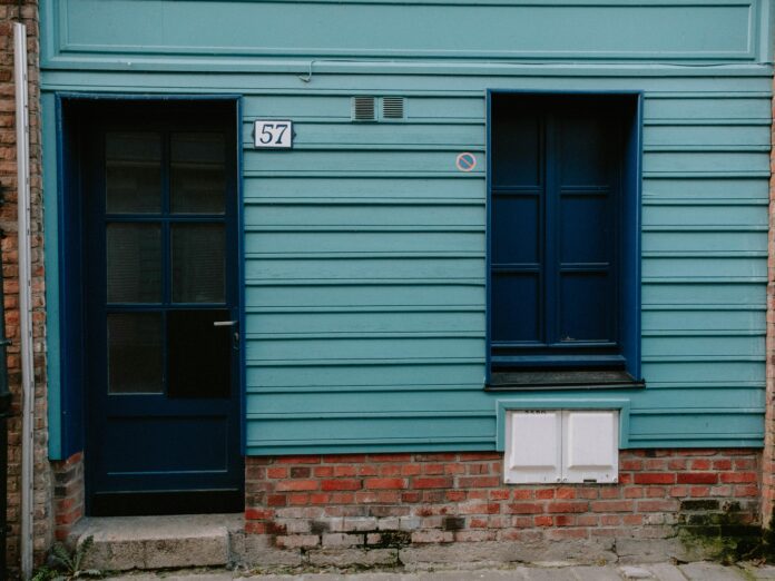 depicting a house with visible foundation cracks and repair work in progress, emphasizing the importance of timely foundation repair.