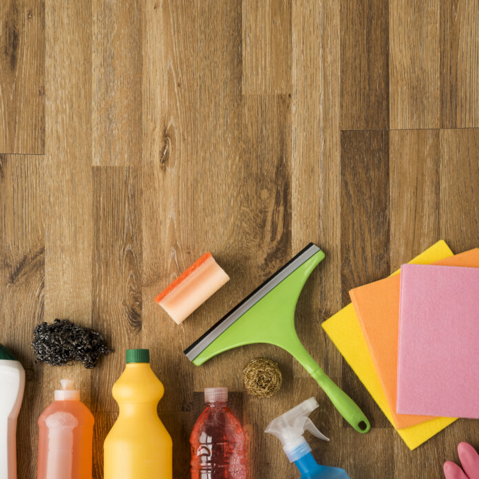 Wood floor maintenance: a clean and shiny hardwood floor with a mop and cleaning supplies