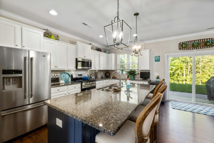 Family living comfortably in their home during a kitchen remodel with a temporary kitchen setup, organized meal prep area, and dust protection measures.